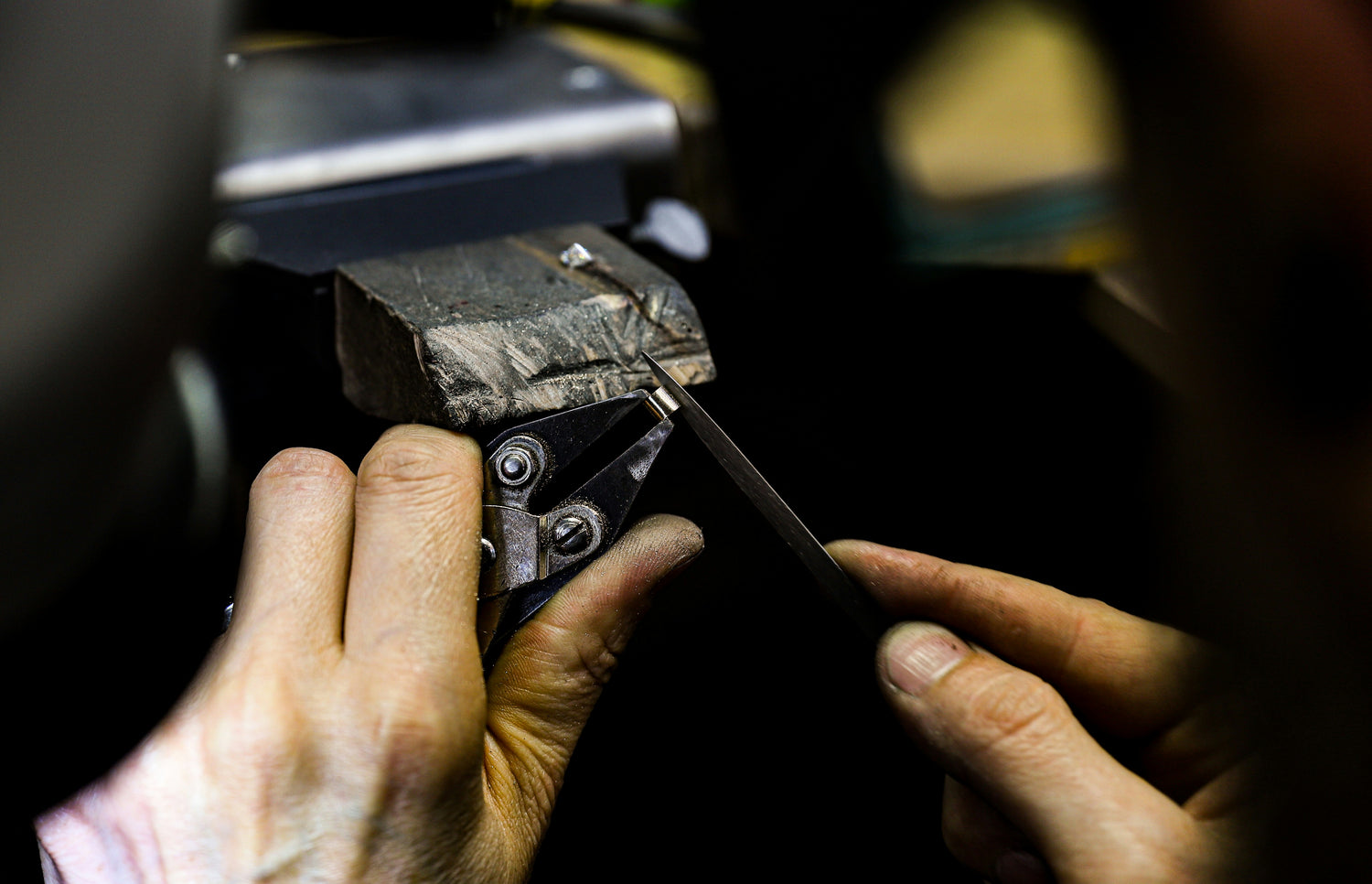 Goldsmith's hands working on a ring
