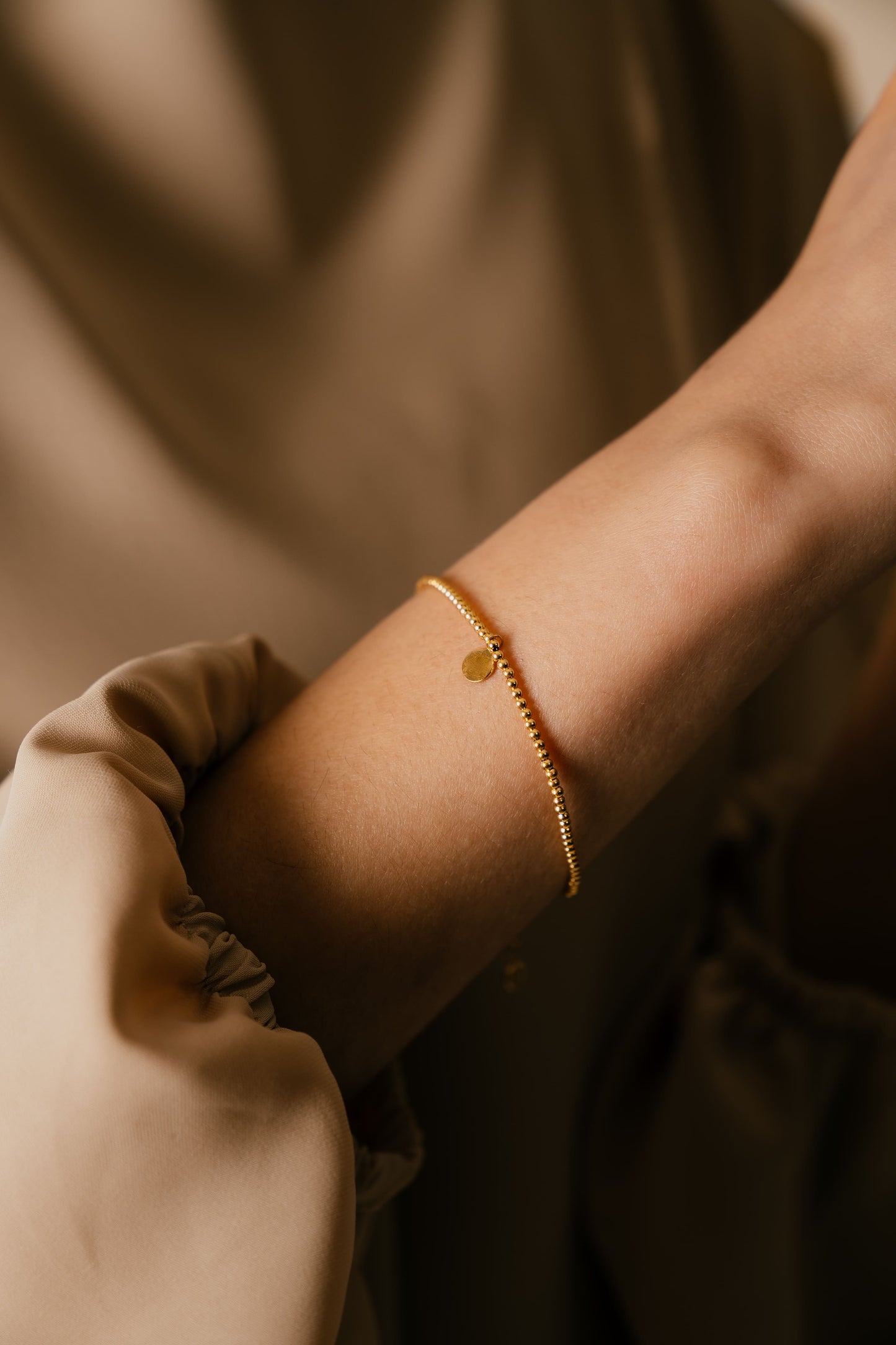 Model wearing Shams 18k gold bracelet by Hafeez Jewellery London