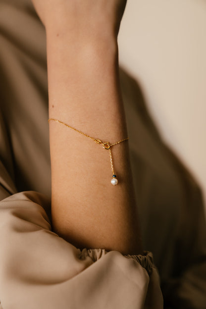 Closeup details of Amira Pearl and Lapis Lazuli 18k Yellow Gold Bracelet by Hafeez Jewellery London on Model