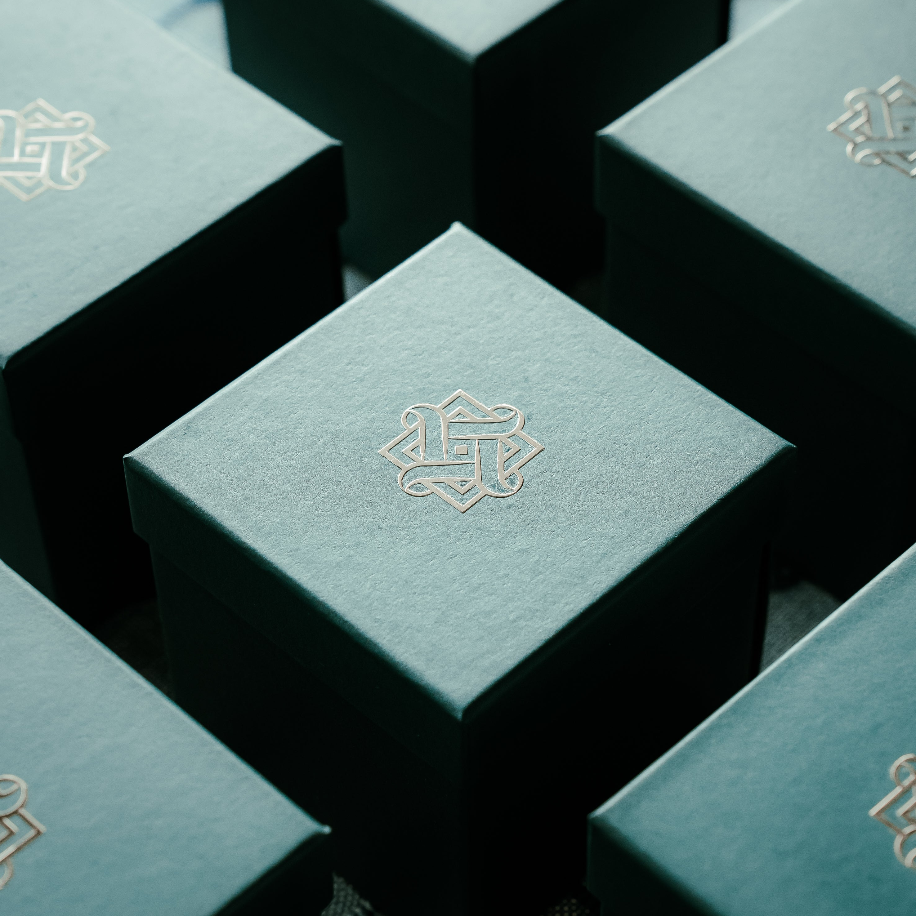 Teal boxes with Hafeez logo on a dark background