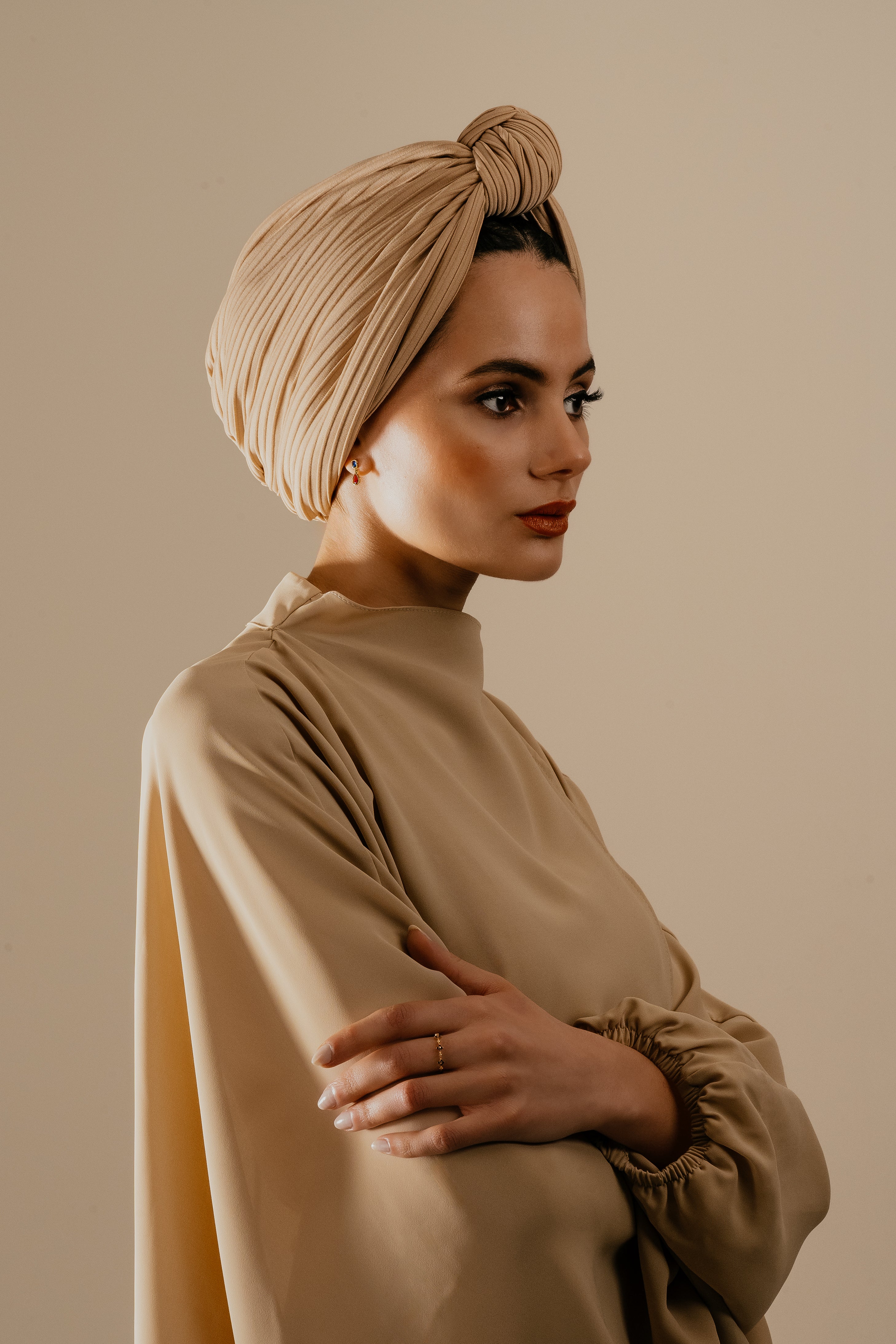 Hafeez Jewellery model wearing a beige dress and turban, and gold jewellery