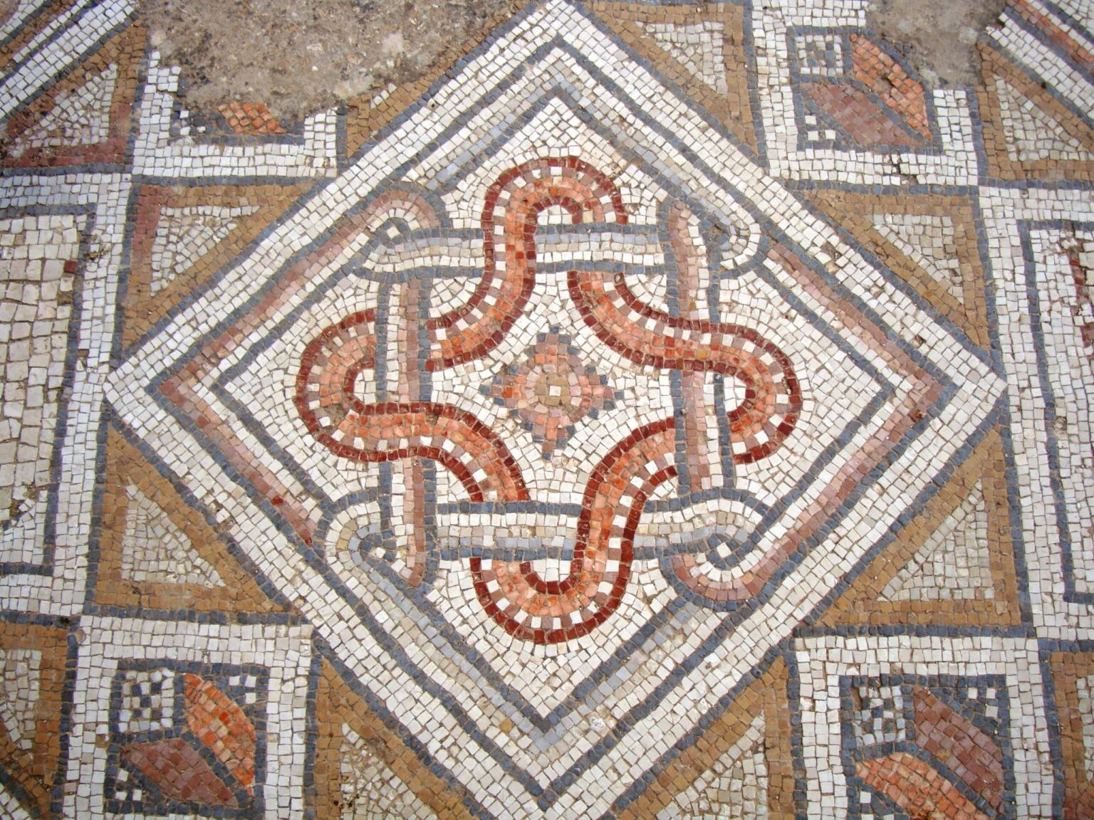 Decorative mosaic with intricate patterns on a stone floor