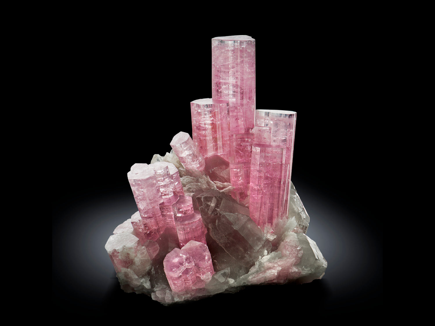 Pink crystal formation on a dark background