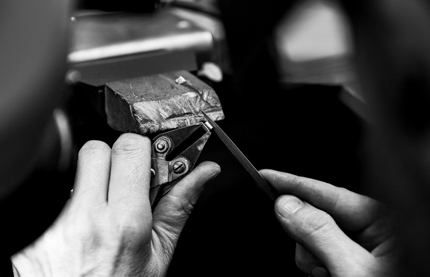 Goldsmith's hands working on a ring