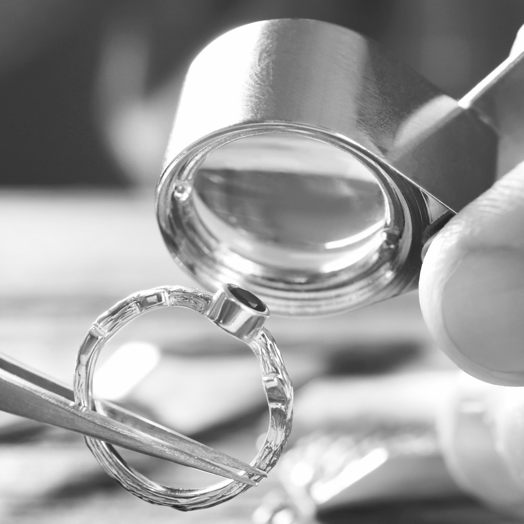 Close-up of a ring being examined with a magnifying glass