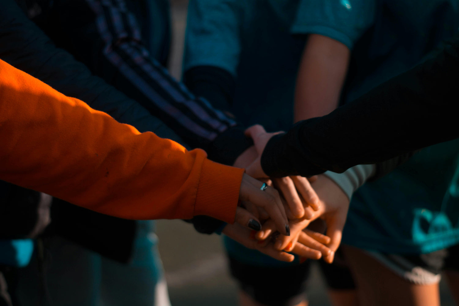 Hands of people stacked together in unity